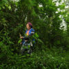 Ismail in Mount Gede, Indonesia, cutting dead twigs to be used as firewood.