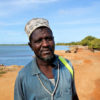 Hafidh Wanje stands near a creek.