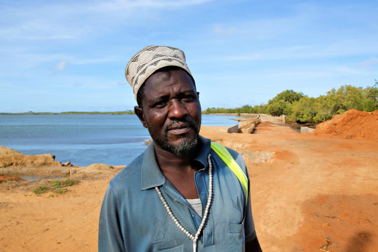 Hafidh Wanje stands near a creek.