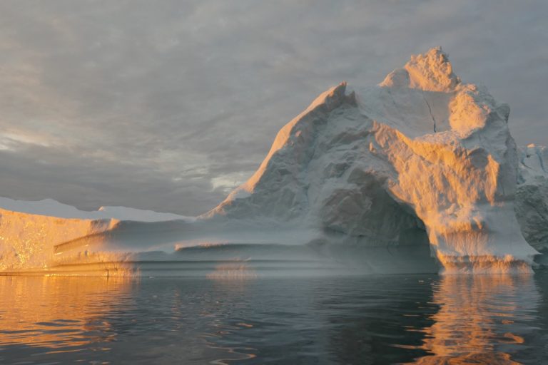 An iceberg floats in Disko Bay, near Ilulissat, Greenland, on July 24, 2015. The massive Greenland ice sheet is shedding about 300 gigatons of ice a year into the ocean, making it the single largest source of sea level rise from melting ice. Image by NASA/Saskia Madlener via Flickr (CC BY-NC-ND 2.0).