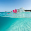 A plastic beverage bottle floats in the shallow waters of Sand Island in Hawaii. Image by David Slater / NOAA Coral Reef Ecosystem Program Marine Debris Team, 2015.