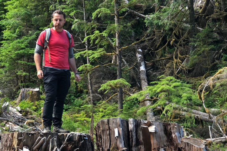 Torrance Coste stands on a stump