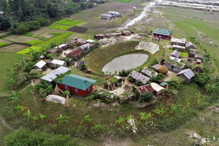 Houses built atop a plinth on one of the islands.