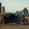 A farmer uses a manure spreader as a natural fertilizer. An excess of manure from livestock produces an excess of ammonia, a harmful nitrogen emission. Image by CityofGeneva via Flickr (CC BY-NC 2.0).