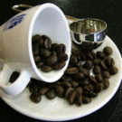 A coffee cup with beans. Photo by Lotus Head/Wikimedia Commons