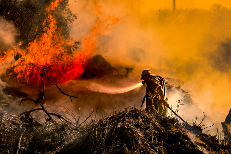 Firefighter fighting a battle against a veld-fire at Ashton Bay, Jeffreys Bay, Eastern Cape Province, Republic of South Africa in March 2017. Photo credit: Steven Terblanch