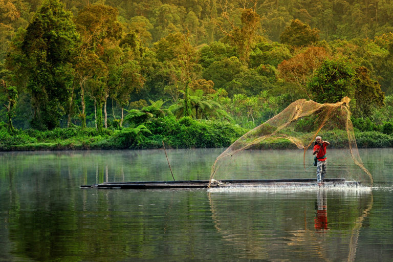 A man fishing in a lake.