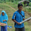 Yasmin trails her son Junaidi on their farm.