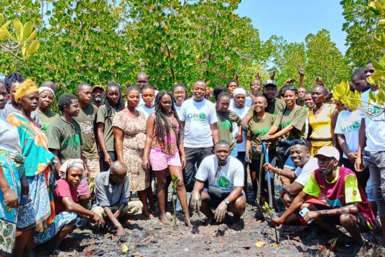 Kelly Banda (center, standing) with volunteers and community members.