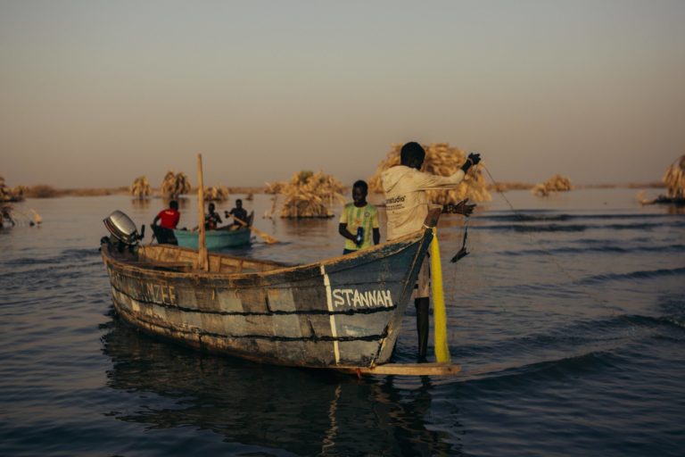 Fishermen at dawn heading out onto Lake Turkana to try their luck for the day. Image by Kang-Chun Cheng.