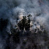 Haze rising from an oil palm plantation and forest in Riau. Photo credit: Rhett A. Butler.