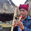 Marselus Selu plays traditional bamboo musical instruments.