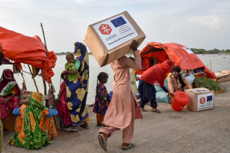 A man carries relief items.