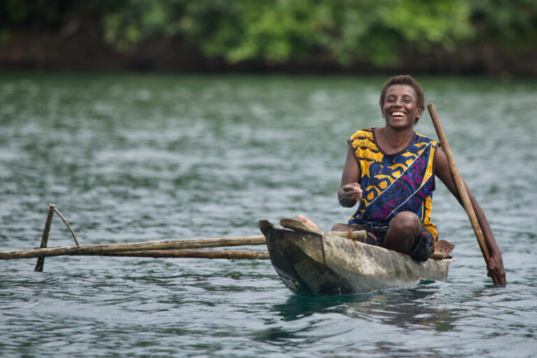 An Indigenous person in a boat.