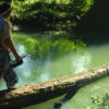 An Indigenous woman crossing a river. Image by Alicia MucúChoc/FAO.
