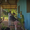 Hairdressser Flávio Mateus do Santo de Sousa cutting the hair of a customer.