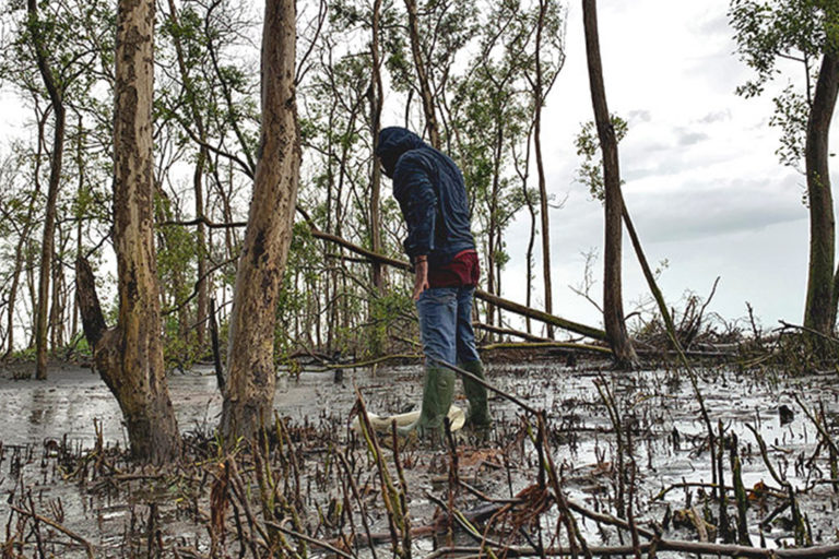 A fisherman looks for crabs.