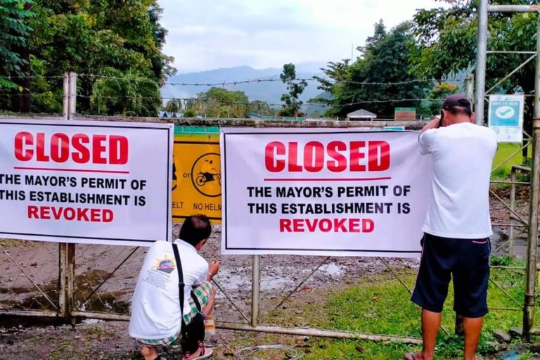 Tampakan government employees close a facility belonging to Sagittarius Mines, Inc.